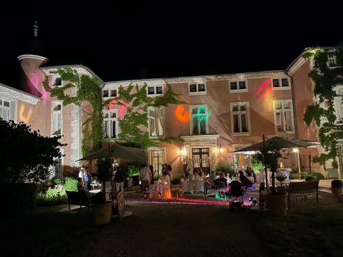 a group of people sitting outside of a building at night at Chateau d Artigues en Provence in Artigues