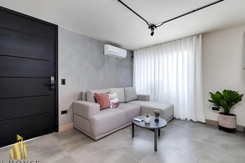 a living room with a couch and a table at Casa Solei 12-7 - Bright & Chic Apt in Manila / AC in El Poblado