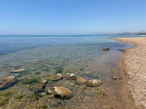 a group of rocks in the water on a beach at Brezza di mare in Zingarello