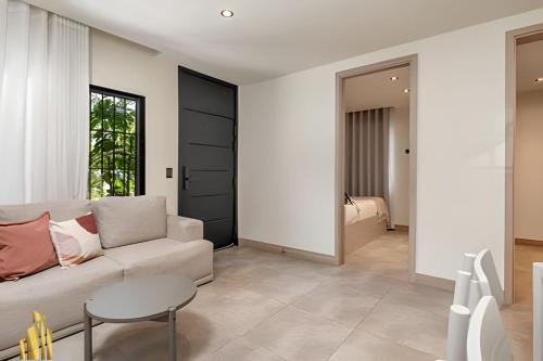 a living room with a white couch and a table at Casa Solei 12-3 - Prime Location: Enjoy El Poblado in El Poblado