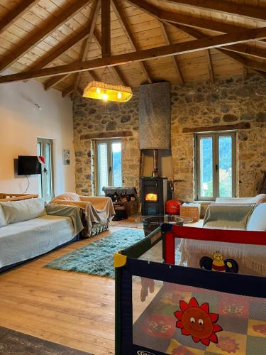 a large living room with a stone wall at Konstantina 2 in Ayía Varvára