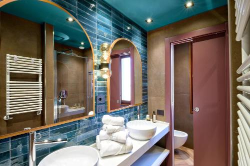 a bathroom with two sinks and a mirror at Hotel Ca' D'Oro - WENICE Deep Culture in Venice