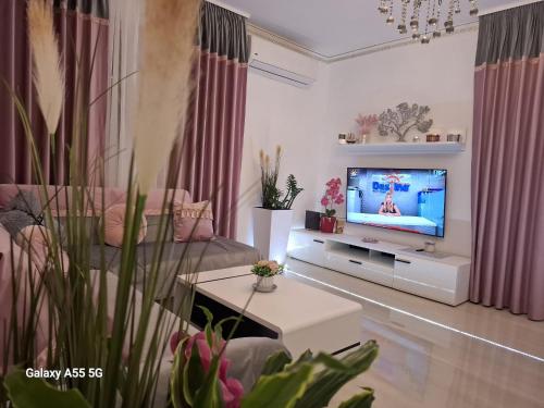 Una sala de estar con un sofá y un televisor. en La Dolce Casa & City Center I Balcony I Netflix, en Bucarest