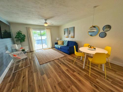 a living room with a table and yellow chairs at NEW - Amazing Sunshine - Up 6 Guests-Private Backyard in Port Orange