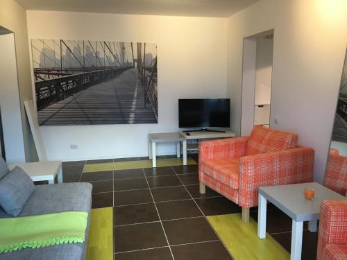 a living room with two couches and a tv at New Central Roof top view in Bucharest