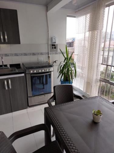 a kitchen with a table and a dining room at Hospedaje Marina - 301 in Ibagué