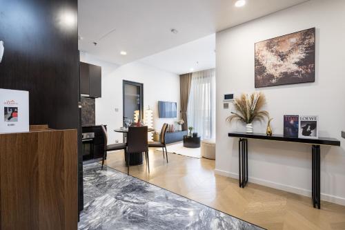 a living room with a table and a dining room at Lumiere Riverside Heera Stay Apartment in Ho Chi Minh City