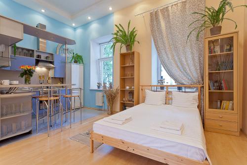 1 dormitorio con 1 cama grande y cocina en Apartments na Lenina, en Minsk