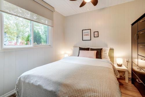 a bedroom with a large bed and a window at The Cozy Shore Cottage - Standard Single in Wasaga Beach