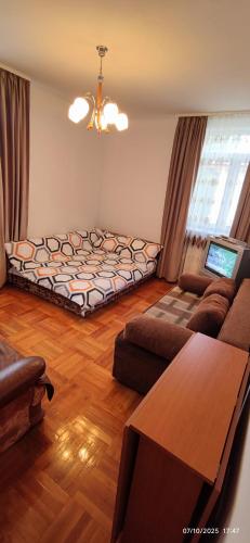 a living room with a bed and a couch at 2 rooms Condo near Zoom Beach in Constanţa