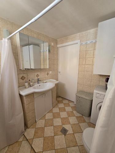 a bathroom with a sink and a toilet at La Casa di Levante in Zakynthos