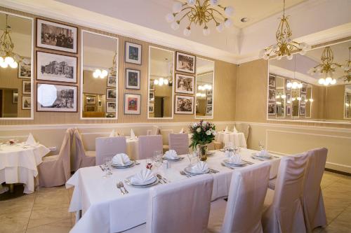 a banquet room with white tables and white chairs at Bristol Palace in Karlovy Vary