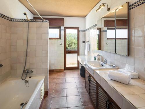 a bathroom with a tub and a sink at Stunning Oceanview Algarve Villa 9 Bedrooms Villa Quinta Marinha Amazing Location Overlooking Sea & Huge Pool Benagil in Lagoa
