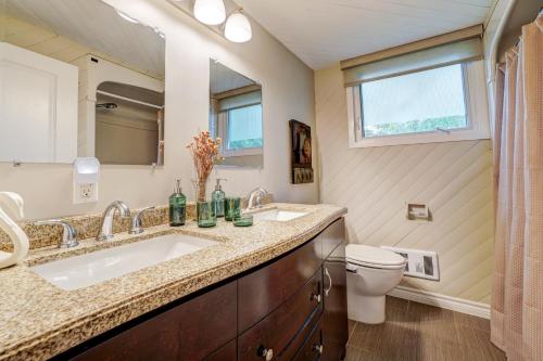 a bathroom with two sinks and a toilet at The Beach House - Steps To Beach Area 3 4br in Wasaga Beach