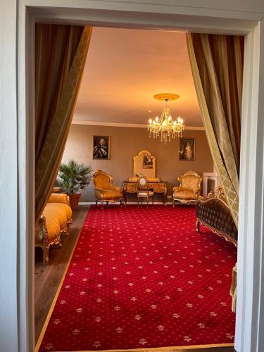 a view of a living room with a red carpet at Schloss Sohland in Sohland