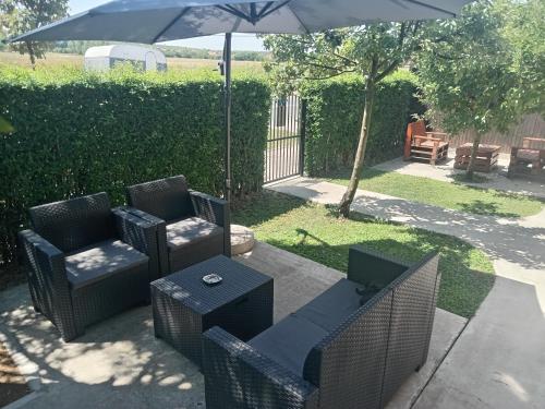 a patio with two chairs and an umbrella at APARTMAN “POD KRALJEVICOM” in Zaječar