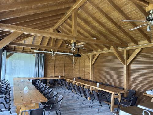 a conference room with a long table and chairs at Apartamenty pod Dębami - noclegi Beskid Niski in Odrzechowa