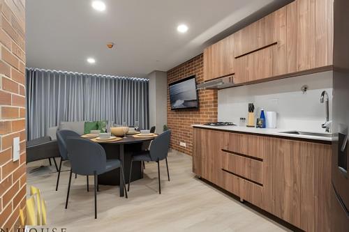 a kitchen and dining room with a table and chairs at Kyux 408 - The hidden gem of Laureles in Alpujarra