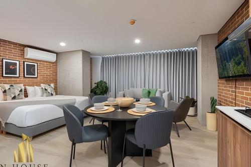 a bedroom with a bed and a dining room with a table at Kyux 408 - The hidden gem of Laureles in Alpujarra