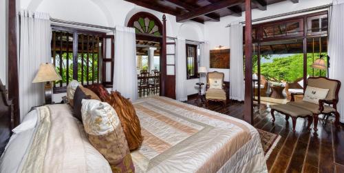 a bedroom with a large bed and a living room at Clingendael Hotel in Digana