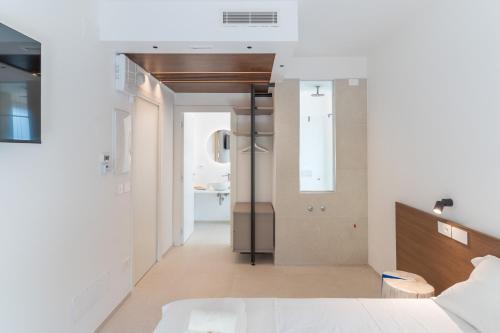 a bedroom with a bed and a bathroom with a sink at Sublimare Luxury Apartments in Giulianova