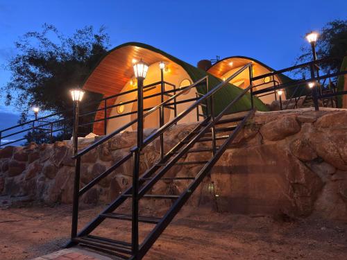 a set of stairs leading up to a dome shaped building at Hobbit Haven in Yelagiri