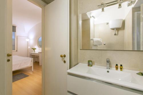 a bathroom with a white sink and a mirror at Rome Central Suite via Porcari in Rome