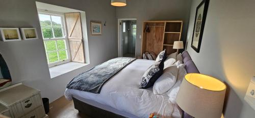 a bedroom with a large bed and a window at Inhoek farm Arniston in Arniston