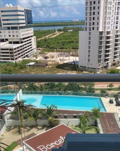 a view from a balcony of a building with a pool at Apartment with a view of the lagoon and pool in Cancún