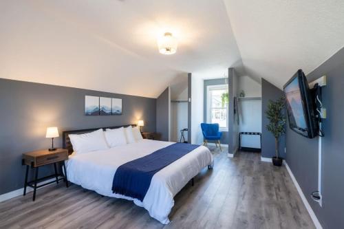 a bedroom with a large bed and a television at Views of Lone Peak and mini golf in Draper
