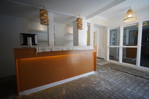 a reception desk in a room with windows and lights at MDE Loisir Tanjis m in Tangier