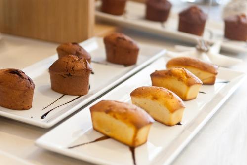 a white plate with different types of desserts on it at Hotel Stella Della Versilia in Marina di Massa
