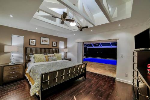 a bedroom with a bed and a large window at Villa Camelot - Gulf Access in Shell Point Village