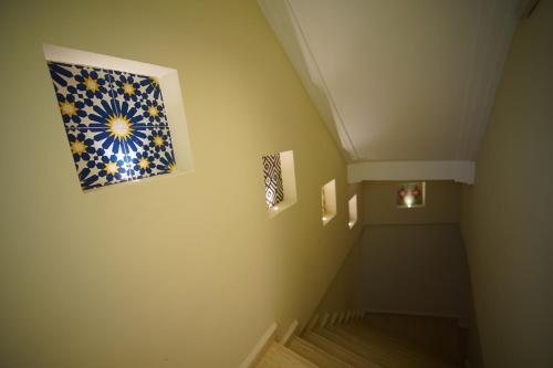 a hallway with a staircase with a painting on the wall at MDE Loisir Tanjis m in Tangier