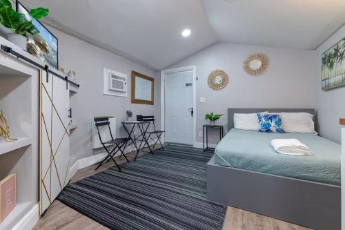 a bedroom with a bed and a table in it at Outdoor Deck Fully Equipped Remodeled Bath in St Petersburg