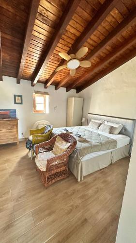 a bedroom with a bed and a ceiling fan at Yoga Farm in Tavira