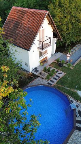 a small blue swimming pool in front of a house at Private Pool & Sun Terrace Pet Friendly Holiday Home in Grabovnica