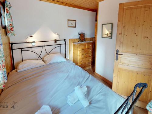 - une chambre avec un lit avec une croix dans l'établissement Chalet confort 10 pers, 5 chambres, Wifi, animaux admis, parking - FR-1-452-59, à Saint-Martin-de-Belleville