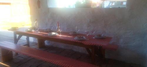 a table in a room with glasses on it at KOÓS VENDÉGHÁZ in Uppony