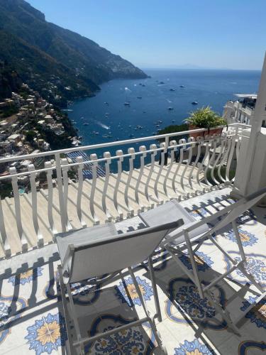 a balcony with chairs and a view of the ocean at Casa Donna Concetta in Positano