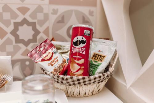 a basket of food and snacks on a table at Casa da Coruja in Rio de Janeiro