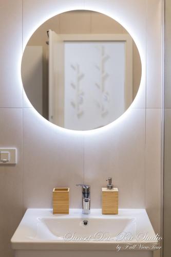 a bathroom with a sink and a mirror at Sunset Da-Ra - Studio DeLuxe with Free Underground parking - by FullViewTour in Timişoara