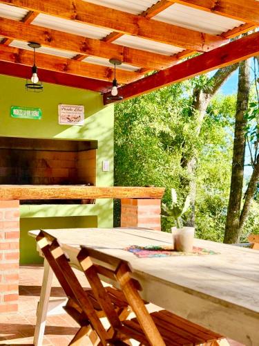 a wooden table and a chair on a patio at MI LUGAR FELIZ Cabaña Misionera in Loreto