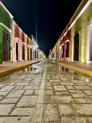 an empty street at night with colorful buildings at Hotel Boutique Casa Zafra in Campeche