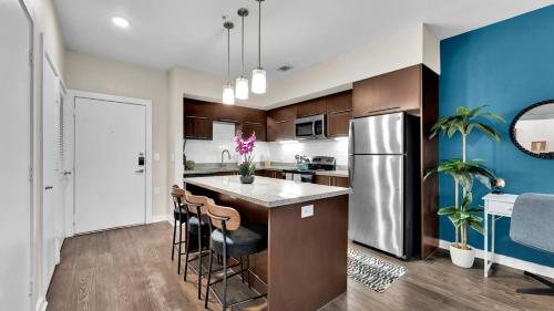 a kitchen with a large island with bar stools at Cozy 1B1B with Pool, Parking, WiFi, Gym 30mnts from Austin in Cedar Park