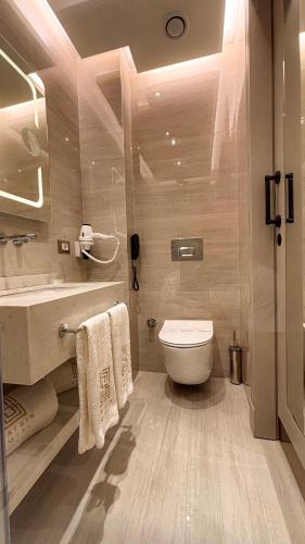 a bathroom with a toilet and a sink at Saygın Hotel Beşiktaş in Istanbul
