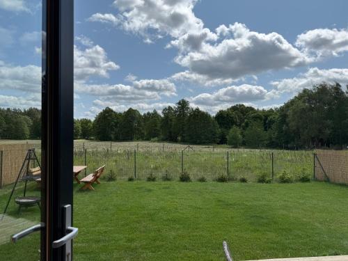a view of a field from a window at PAKLADA Domek całoroczny 1 in Bak