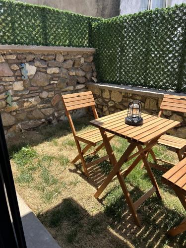 a picnic table and two chairs with a lantern on it at Charming Stone Studio with Balcony & Breakfast-8 in Ayvalık