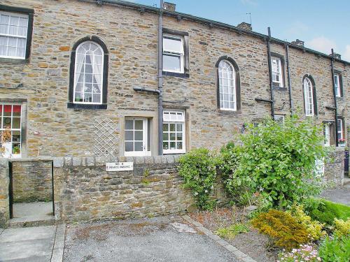 an old brick building with many windows on it at 6 Craven Terrace in Skipton