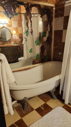a white bath tub in a bathroom with a window at Hacienda Siesta Alegre in Rio Grande